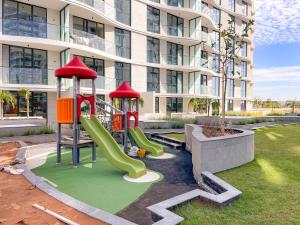 a playground in front of a building with a slide at FIRST CLASS Studio Beach View Living Bliss in Ras al Khaimah