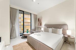 a bedroom with a large bed and a living room at FIRST CLASS Studio Beach View Living Bliss in Ras al Khaimah +24 photos