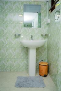 a bathroom with a sink and a mirror at Zeylon Villa Talalla in Matara