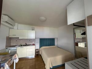 a small bedroom with a bed and a sink in it at Residence Casa Maria in Assenza di Brenzone +29 photos