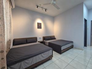 a bedroom with two beds in a room at Lim'S Homestay Kudat in Kudat