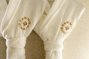 a pair of white socks with gold embroidery on them at Hôtel Casimir in Paris
