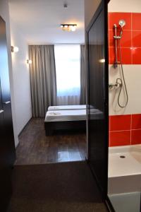 a bathroom with a bath tub and a shower at Hotel Artimino in Timişoara +37 photos