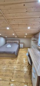 a bedroom with a bed and a wooden ceiling at B apartment Рахів in Rakhiv