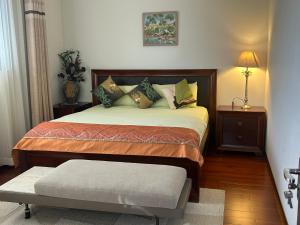 a bedroom with a large bed with pillows at Midby's Elegant Guesthouse - 2 En-suite Rooms & 2 Rooms with Shared Bathroom in Perth