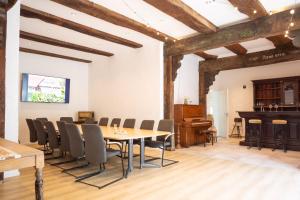 a room with a table and chairs and a piano at Fewo Wolke in Menslage
