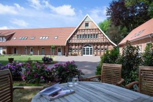a wooden table in front of a building at Fewo Wolke in Menslage