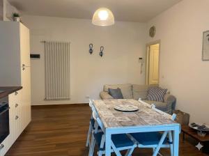 a living room with a blue table and a couch at PIOPPETO OVEST - Premium Villas in Giulianova +1 photo