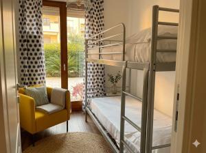 a room with two bunk beds and a chair at PIOPPETO OVEST - Premium Villas in Giulianova