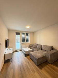 a living room with a couch and a table at Mid-Town Spacious Apartment in Banská Bystrica