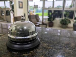 a bell sitting on top of a table at Bonno Hotel Paulínia in Paulínia