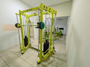 a gym with a squat rack and weights at Bonno Hotel Paulínia in Paulínia