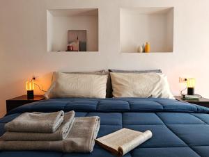 a bedroom with a blue bed with towels on it at Il cantuccio di Federico in Radicofani