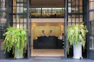 two women standing in the lobby of a building at Hotel Once Bangkok in Bangkok
