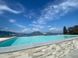 a swimming pool with a view of the water at MyLago in Baveno