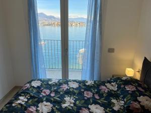 a bedroom with a bed and a window with a view at MyLago in Baveno
