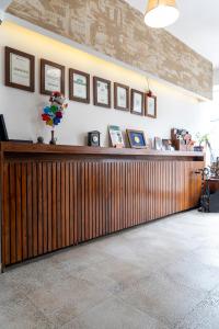 a large wooden counter in a room with pictures on the wall at Garni Konak Hotel By Blanket Collection in Sarajevo