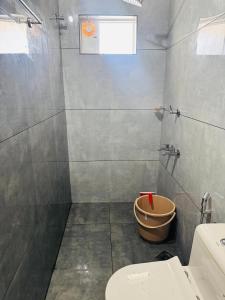 a bathroom with a toilet and a shower at Zara Homes in Alleppey +27 photos