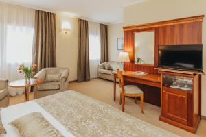 a hotel room with a bed and a flat screen tv at Boutique Hotel Korana Srakovcic in Karlovac