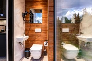 a bathroom with two toilets and a sink and a shower at Luxury Resort Orava in Orava +15 photos