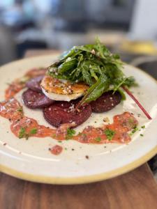 a plate of food with meat and greens on it at Gasthaus - Hotel Neue Post in Meitingen