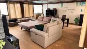 a living room with a couch and a bed at Giulia By The Sea in Follonica