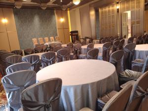 a conference room with white tables and chairs at La Belle - The Business Hotel in Lubumbashi