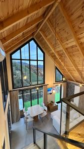a living room with a table and a large window at Çavdi Villa in Ardeşen