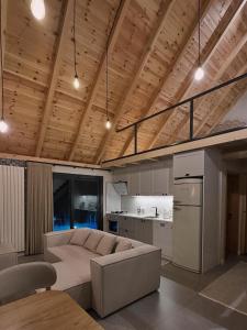 a living room with a couch and a kitchen at Çavdi Villa in Ardeşen