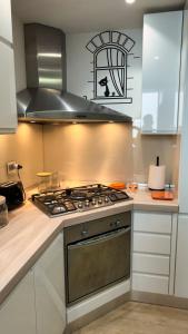 a kitchen with a stove top oven in a kitchen at Giulia By The Sea in Follonica +30 photos
