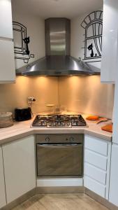 a kitchen with a stove and a hood at Giulia By The Sea in Follonica