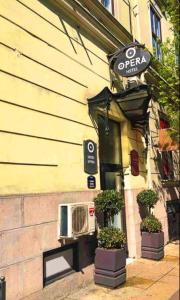 a sign on the side of a building with a air conditioner at Hotel Opera Garni in Belgrade