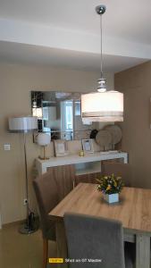 a dining room with a table and a lamp at Jardines del Mar 1 in El Borseral
