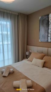 a bedroom with a large bed with two pillows on it at Jardines del Mar 1 in El Borseral +26 photos