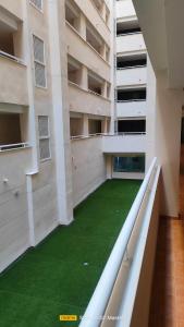 an apartment building with a green lawn in the middle at Jardines del Mar 1 in El Borseral