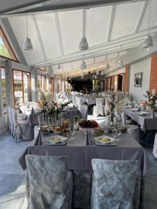 a dining room with tables and chairs with plates of food at Przystań nad Sołą in Bielany