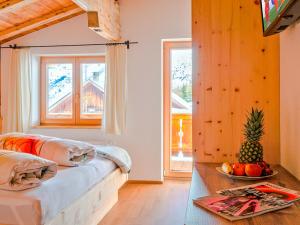 a room with a couch and a table with a bowl of fruit at Berghütte Kneisl in Sölden