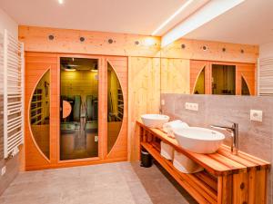 two sinks in a bathroom with wooden walls at Berghütte Kneisl in Sölden