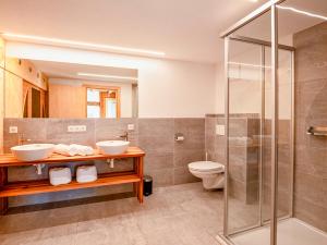 a bathroom with two sinks and a shower at Berghütte Kneisl in Sölden