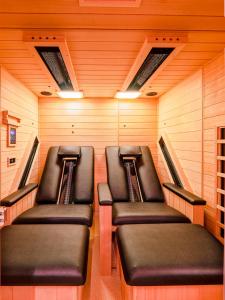 a row of leather seats in a train room at Berghütte Kneisl in Sölden +7 photos