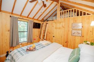 a bedroom with a bed with a table on it at Little Pine Lodge At Saddlecreek in Thomasville