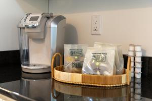 a basket of food sitting next to a food processor at Mimosa Cottage - Thomasville Charm in Thomasville