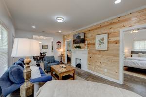 a living room with a bed and a fireplace at Mimosa Cottage - Thomasville Charm in Thomasville