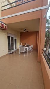 a patio with a table and chairs on it at Apartamento junto al mar in Vera