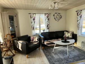 a living room with a couch and a table at Haga gård och Stall in Herräng