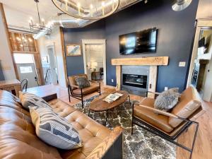 a living room with a couch and a fireplace at Historical Boiler Maker Turns Vacation Destination in Muskegon