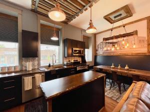 a large kitchen with a table and a couch at Historical Boiler Maker Turns Vacation Destination in Muskegon