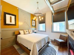 a bedroom with a bed and some windows at Historical Boiler Maker Turns Vacation Destination in Muskegon
