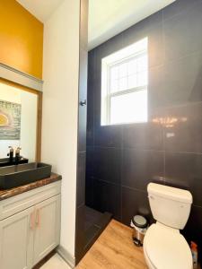 a bathroom with a toilet and a sink and a window at Historical Boiler Maker Turns Vacation Destination in Muskegon +32 photos