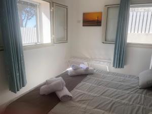 a bedroom with a bed with towels on it at villa ingrassia in Favignana